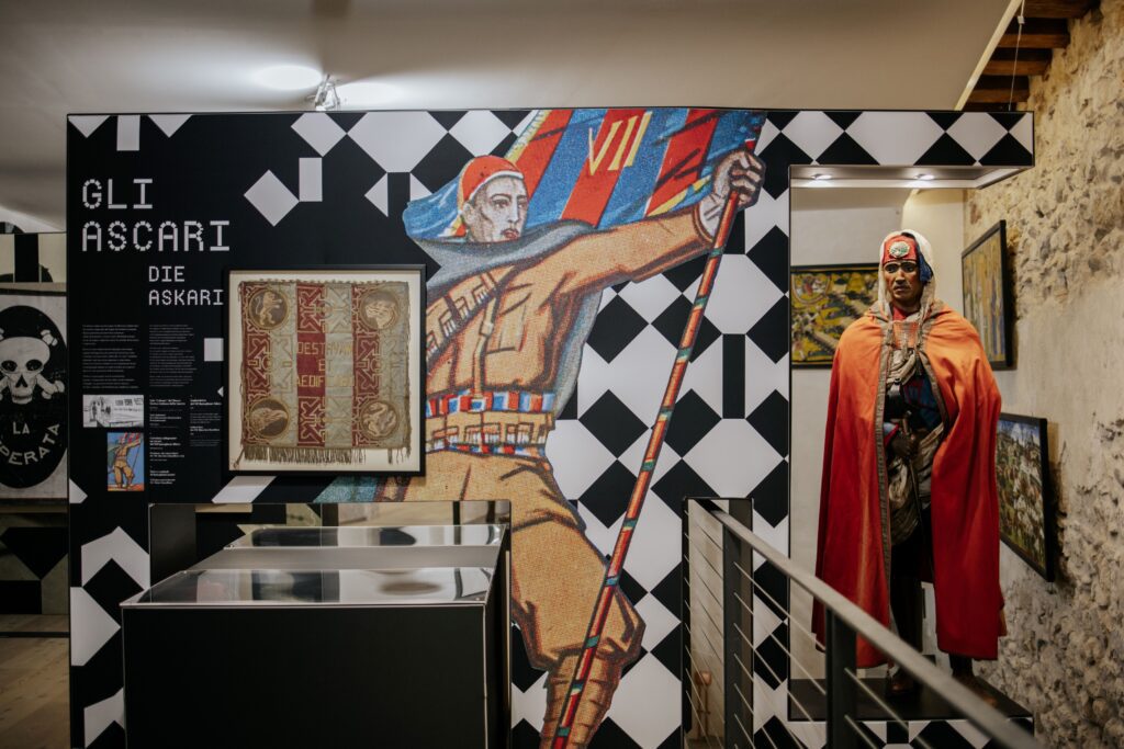 Sala della mostra E noi che ne sappiamo? dedicata agli ascari, con un manichino in mantello rosso