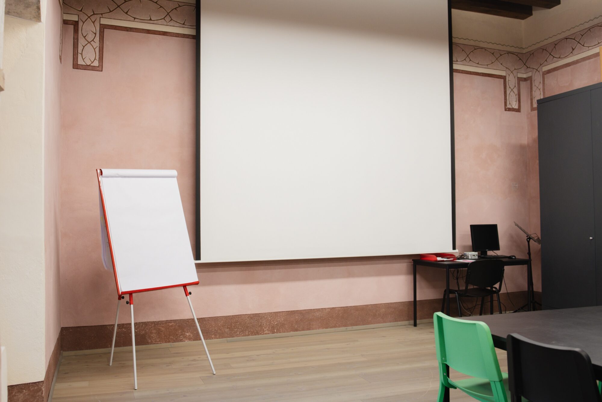 Schermo per proiezioni e lavagna a fogli in una sala per riunioni
